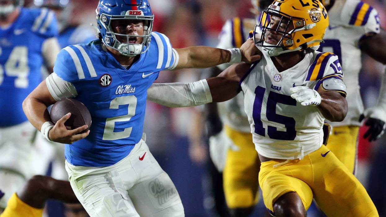 Jaxson Dart (2) runs the ball as LSU Tigers defensive back Sage Ryan (15) attempts to make the tackle
