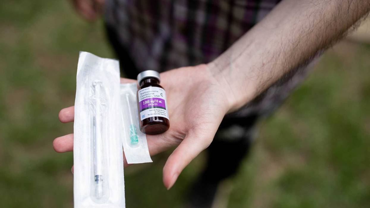 Jay Galante holds a bottle of the testosterone he is prescribed to take by his Planned Parenthood healthcare provider for his gender transition along with the needle he uses to inject it.