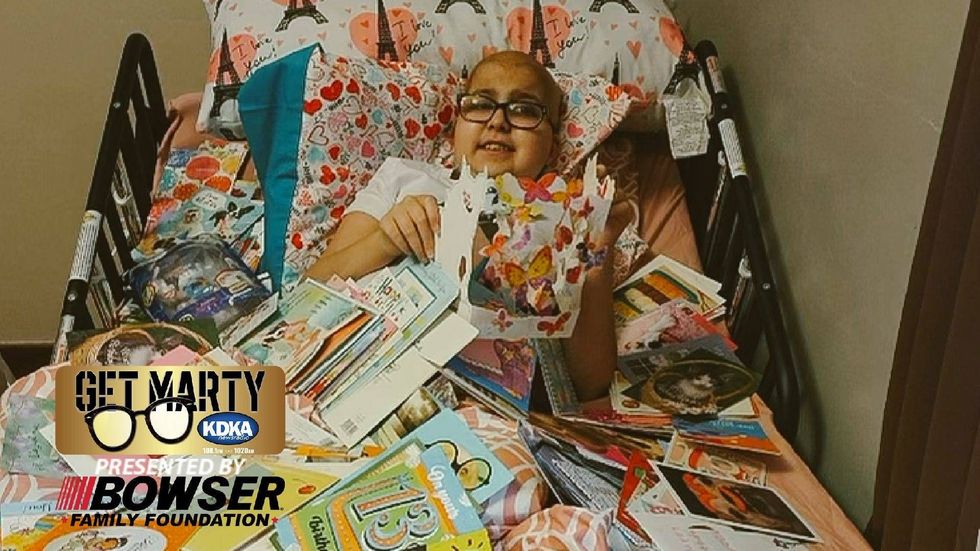 Jaycee Amick, 13, at home surrounded by thousands of birthday cards.