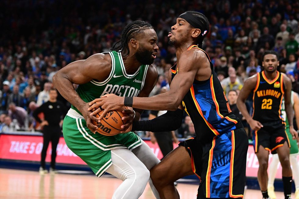 Jaylen Brown #7 of the Boston Celtics and Shai Gilgeous-Alexander #2 of the Oklahoma City Thunder fight for the ball during the second half at Paycom Center on January 5, 2025 in Oklahoma City, Oklahoma.
