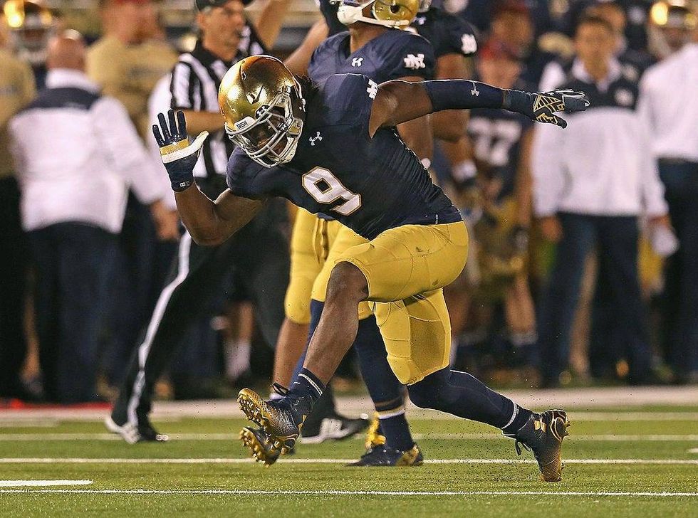 Jaylon Smith #9 of the Notre Dame Fighting Irish celebrates a tackle for a loss against the Michigan Wolverines at Notre Dame Stadium on September 6, 2014 in South Bend, Indiana. Notre Dame defeated Michigan 31-0.