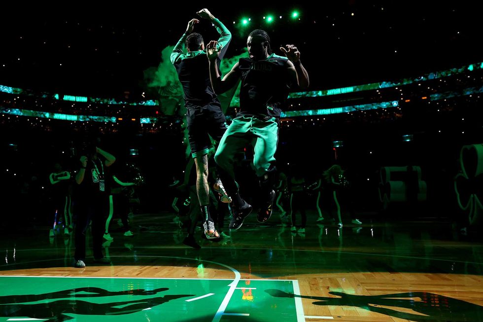 Jayson Tatum #0 and Jaylen Brown #7 of the Boston Celtics jump together after being announced before the game against the Indiana Pacers at TD Garden on December 27, 2024 in Boston, Massachusetts.