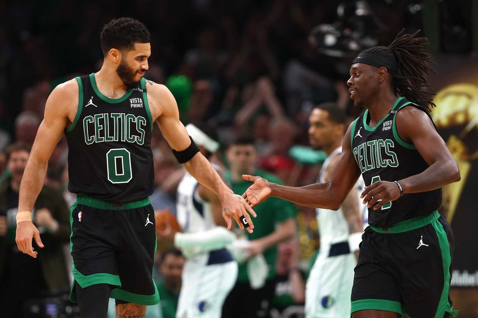 Jayson Tatum #0 and Jrue Holiday #4 of the Boston Celtics high five during the third quarter against the Dallas Mavericks in Game Two of the 2024 NBA Finals at TD Garden on June 09, 2024 in Boston, Massachusetts.