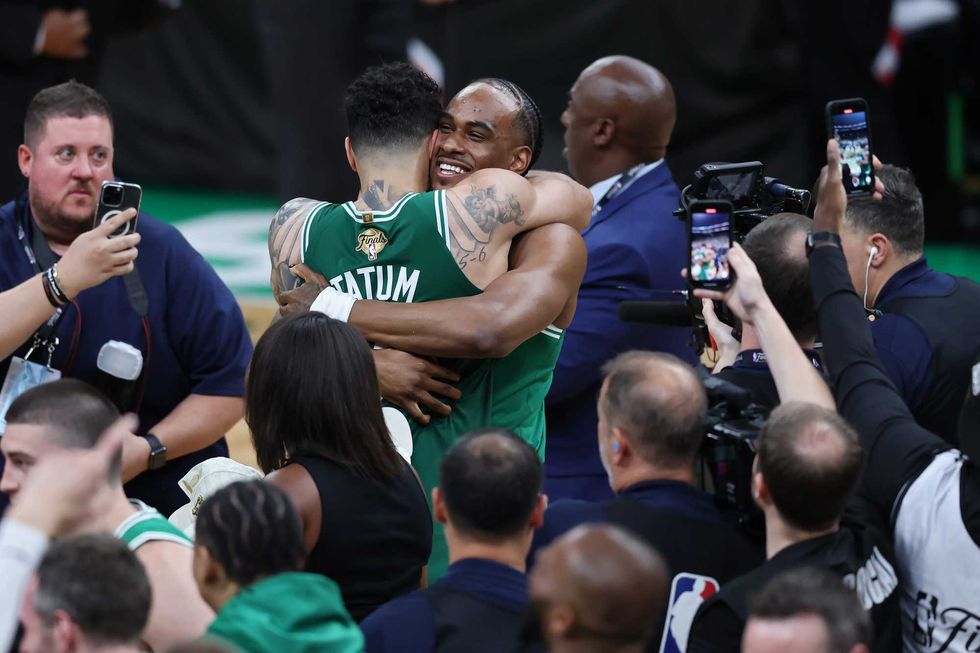 Jayson Tatum #0 of the Boston Celtics celebrates with Oshae Brissett #12 after defeating the Dallas Mavericks in Game Five to win the 2024 NBA Finals at TD Garden on June 17, 2024 in Boston, Massachusetts.