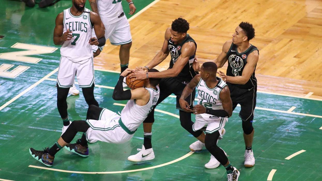 Jayson Tatum battles Giannis Antetokounmpo for the ball