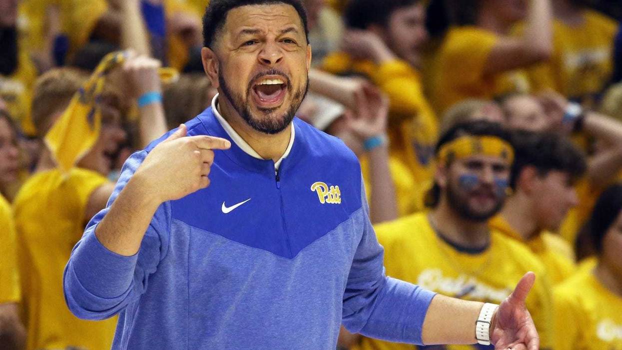 Jeff Capel with Zoo behind him