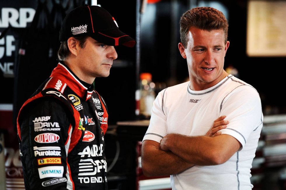 Jeff Gordon, driver of the #24 Drive to End Hunger Chevrolet, talks to AJ Allmendinger, driver of the #22 Shell/Pennzoil Dodge, during practice for the NASCAR Sprint Cup Series Goody