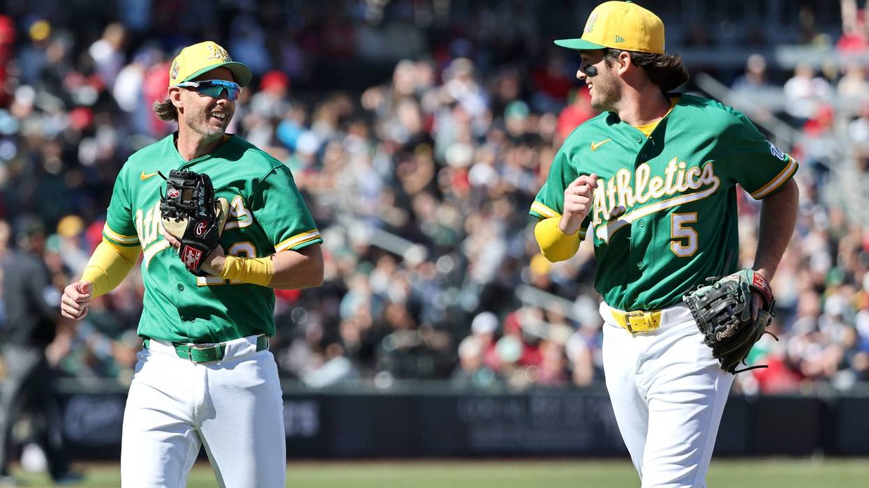 Jeff McNeil #22 and Jacob Wilson #5 of the Athletics run off the field after the Athletics turned a double play against the Los Angeles Angels in the second inning of a spring training game at Las Vegas Ballpark on March 07, 2026 in Las Vegas, Nevada.