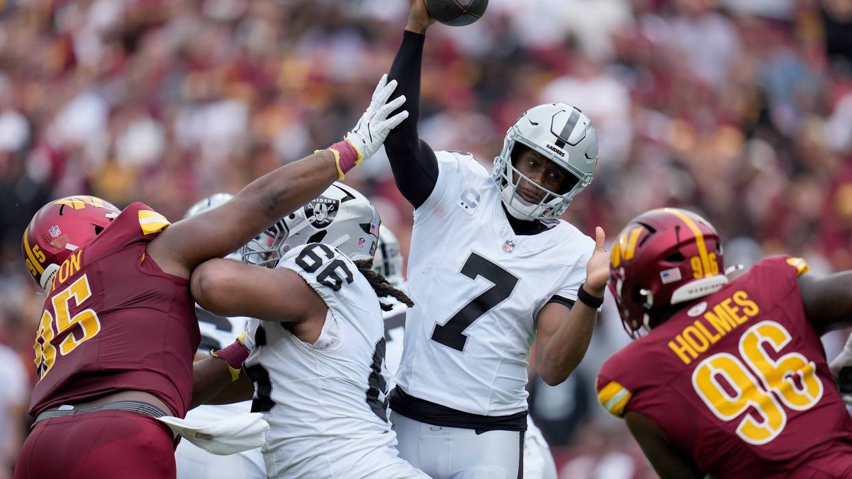 Jer'Zhan Newton #95 of the Washington Commanders puts pressure on Geno Smith #7 of the Las Vegas Raiders during the second quarter at Northwest Stadium on September 21, 2025 in Landover, Maryland.