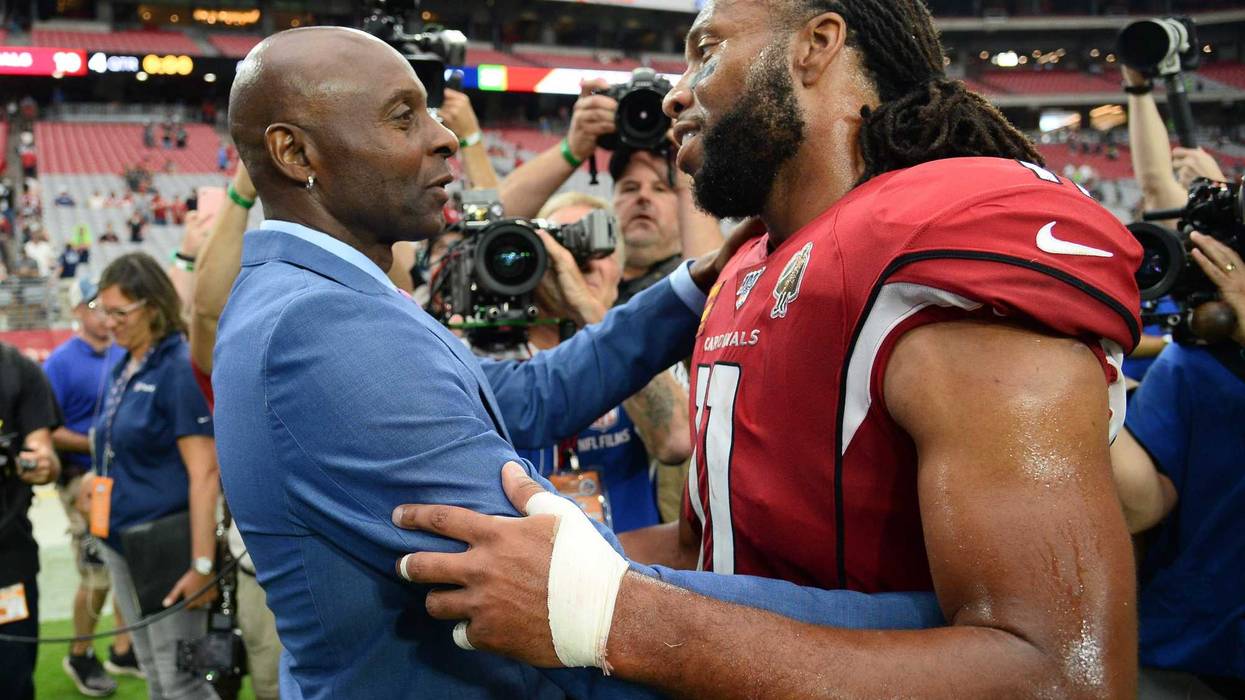Jerry Rice and Larry Fitzgerald catch up after a game