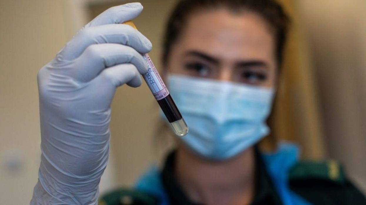Jess Baddams, paramedic, holds a blood sample as she poses for a photograph during an antibody testing program at the Hollymore Ambulance Hub of the West Midlands Ambulance Service, operated by the West Midlands Ambulance Service NHS Foundation Trust, on June 5, 2020 in Birmingham, England.