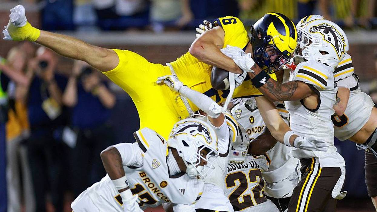 JJ Buchanan #6 of the Michigan Wolverines catches a game winning pass with no time left on the clock