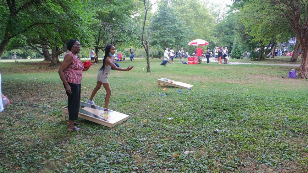 Joan Wooten and Keilah Dancy play a game of cornhole during Senior Fun Day in Fairmount Park.