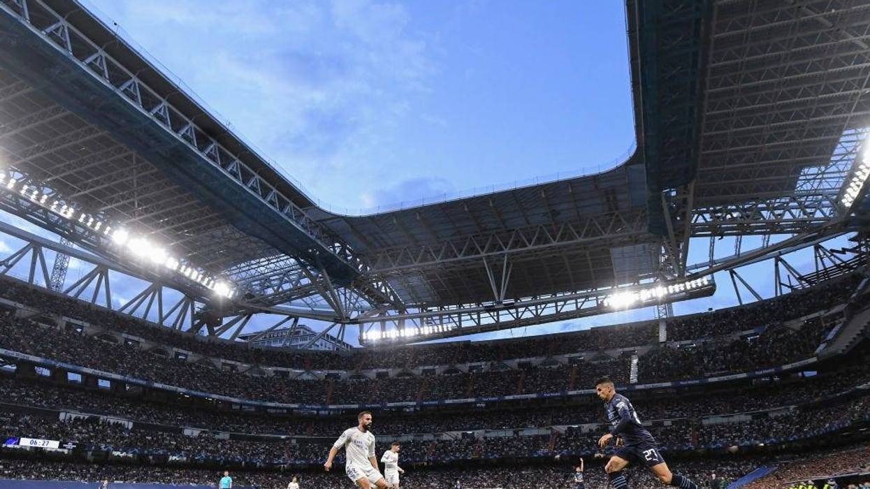 Joao Cancelo of Manchester City FC competes for the ball with Dani Carvajal of Real Madrid CF during the UEFA Champions League Semi Final Leg Two match between Real Madrid and Manchester City at Estadio Santiago Bernabeu on May 04, 2022 in Madrid, Spain.