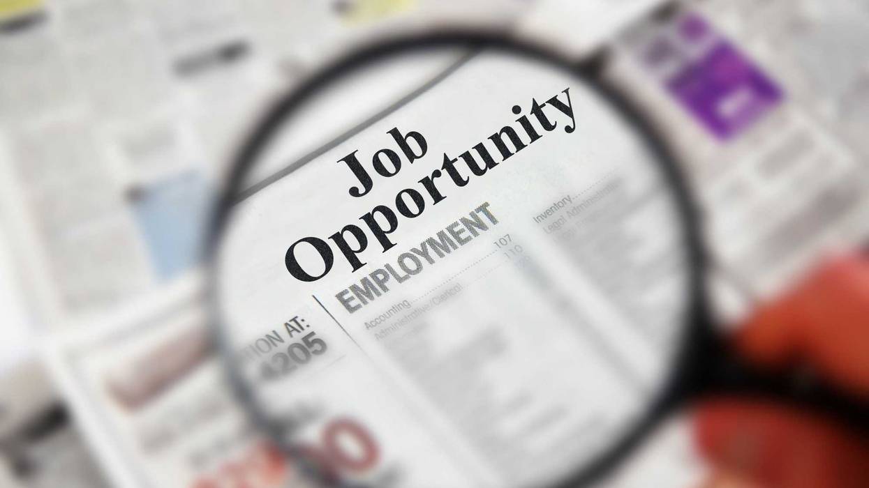 job search in newspaper using magnifying glass