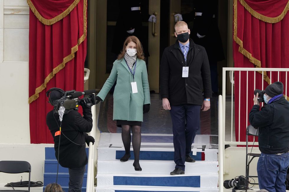 "JOE BIDEN" AND "JILL BIDEN:" Stand-ins for President-elect Joe Biden and Dr. Jill Biden walk on to the podium during a rehearsal for the inaugural ceremony for President-elect Joe Biden and Vice President-elect Kamala Harris on January 18, 2021 in Washington, DC.