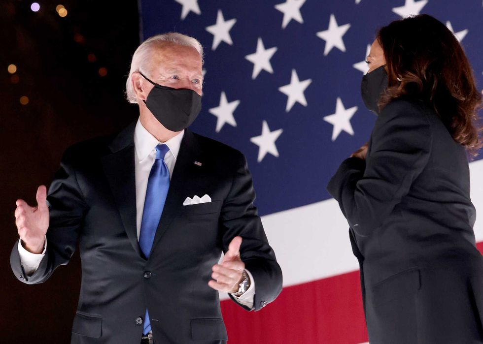 Joe Biden and Kamala Harris confer on stage outside the Chase Center after Biden delivered his acceptance speech on the fourth night of the Democratic National Convention from the Chase Center on August 20, 2020 in Wilmington, Delaware.