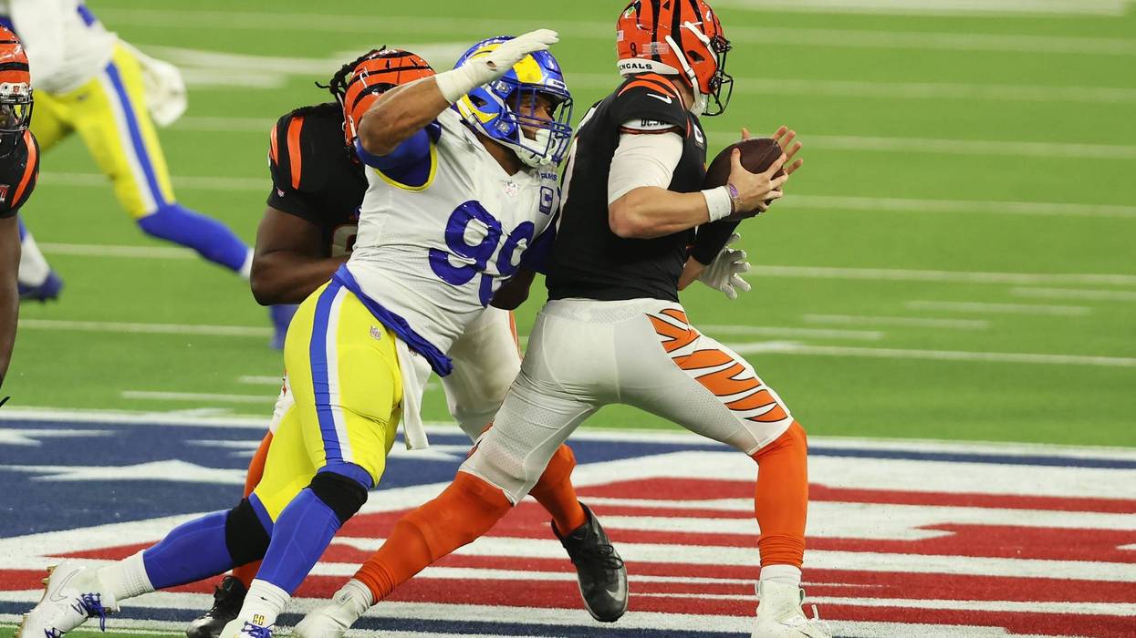 Joe Burrow #9 of the Cincinnati Bengals is sacked by Aaron Donald #99 of the Los Angeles Rams in the fourth quarter during Super Bowl LVI at SoFi Stadium on February 13, 2022 in Inglewood, California.