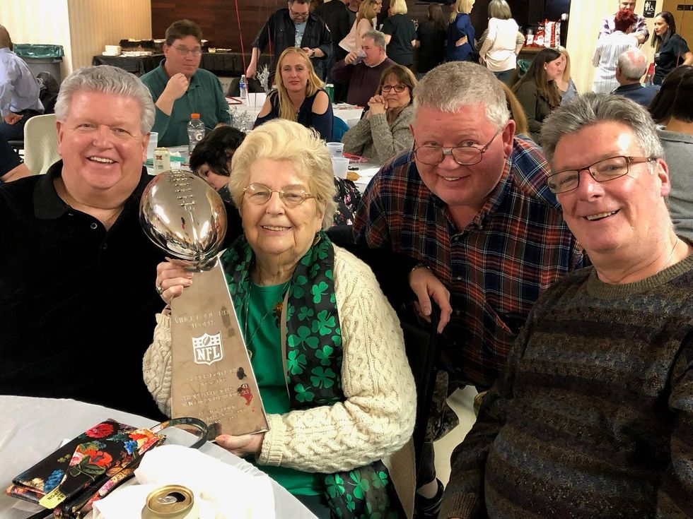Joe Flatley (middle right) poses for a picture with his mom holding the Lombardi Trophy (middle left) and two brothers (far left and far right).