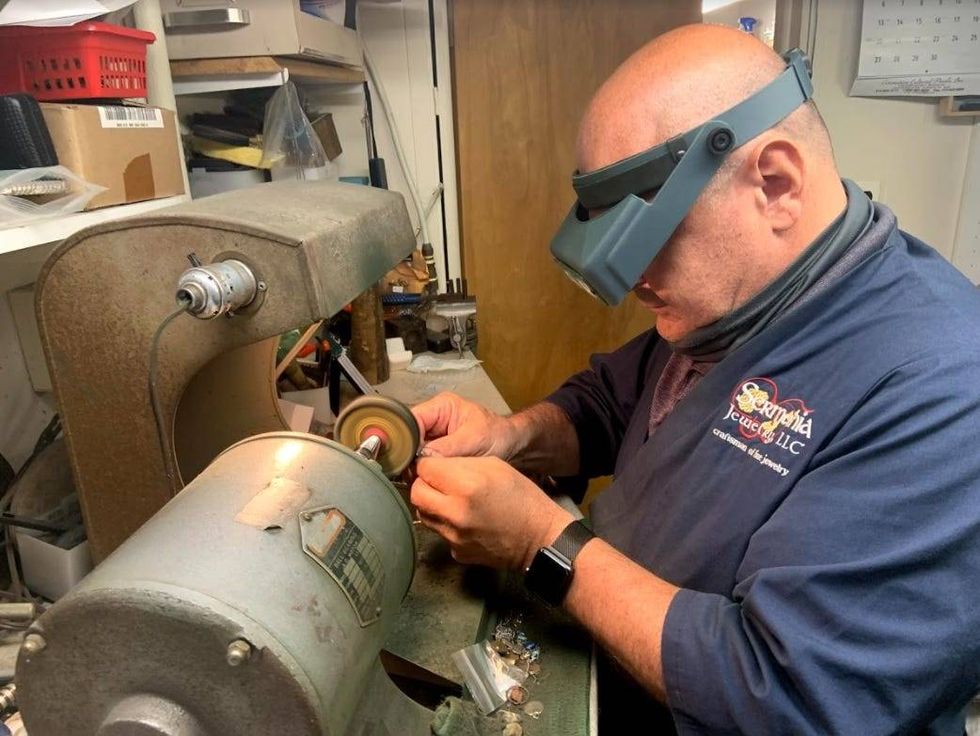 Joe Sermania working inside Sermania Jewelry.