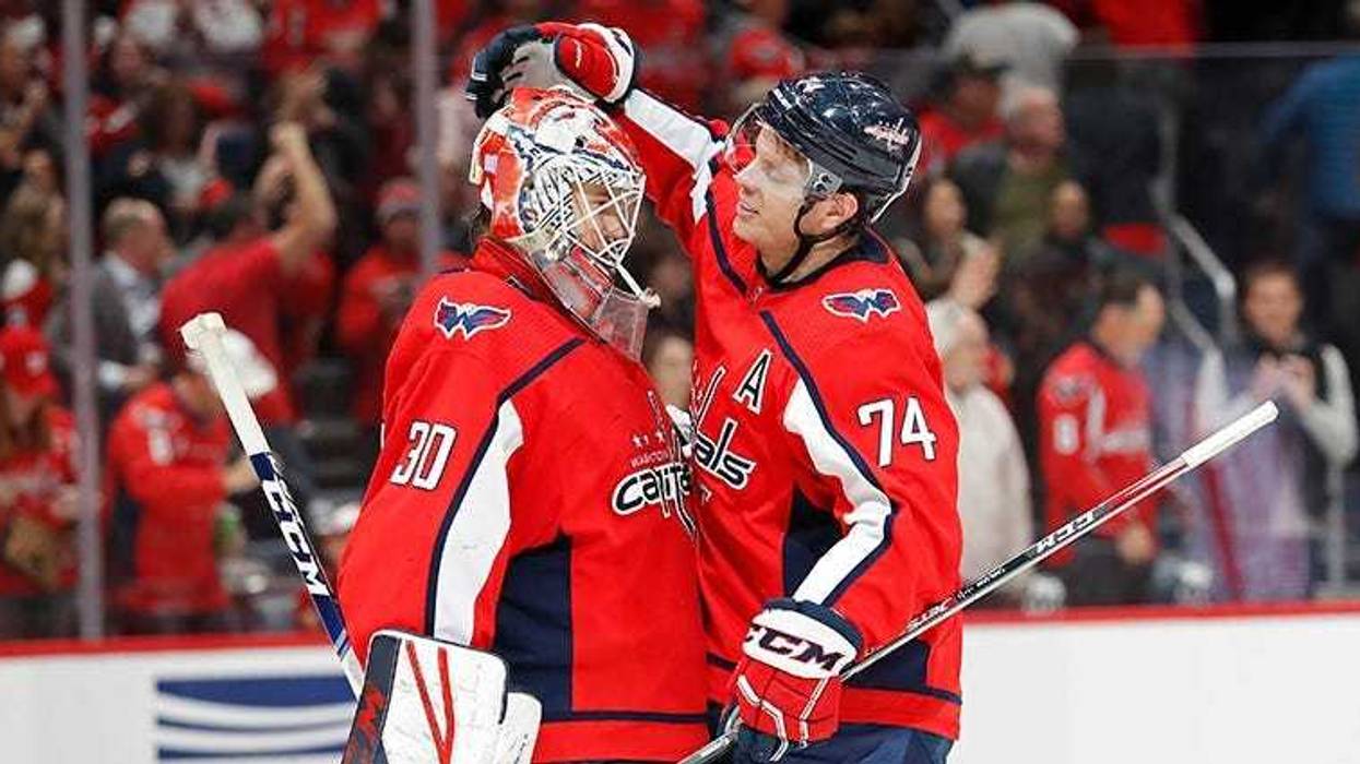 John Carlson celebrates a win with rookie goaltender Ilya Samsonov