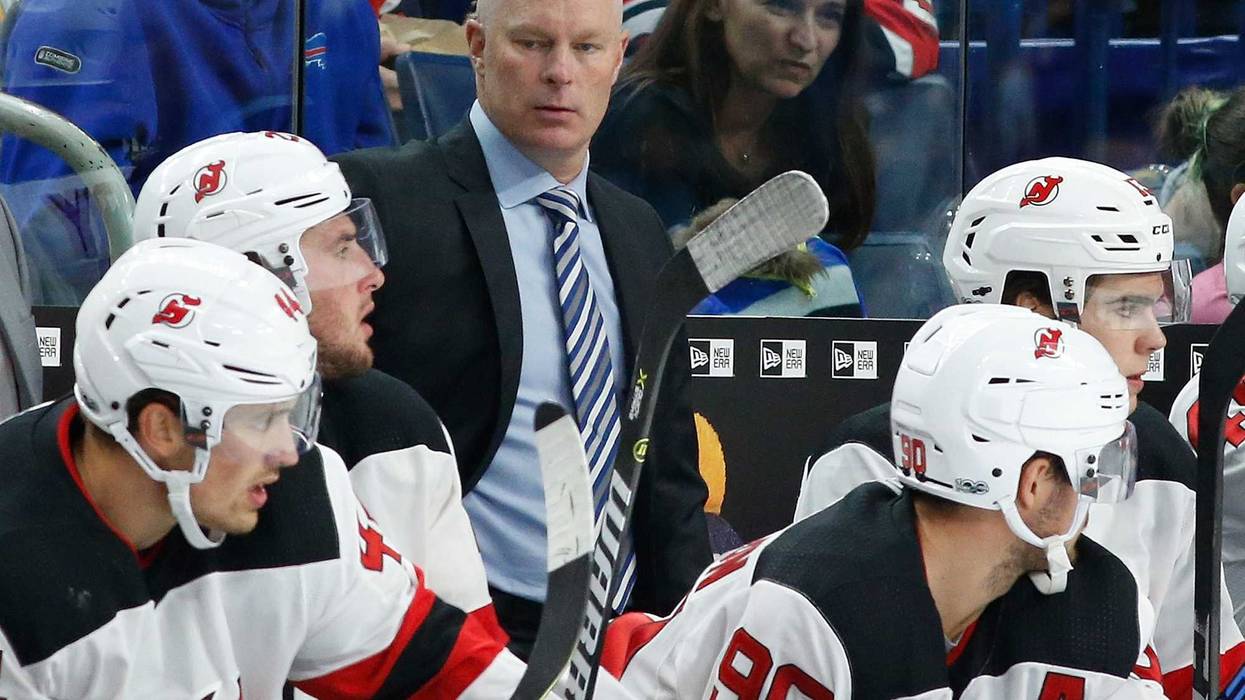 John Hynes watches play from the bench.