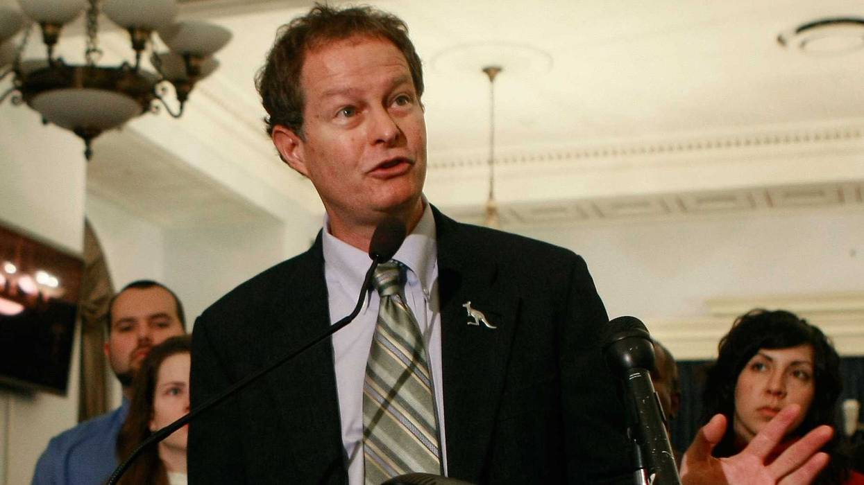 John Mackey, CEO of Whole Foods, speaks while surrounded by Whole Foods employees during a news conference on Capitol Hill, December 9, 2008 in Washington, DC.
