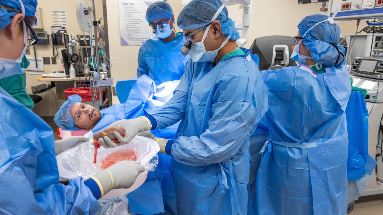 John Nicholas, 28, looks at a donated kidney moments before doctors at Northwestern Medicine began a procedure to surgically transplant the kidney into Nicholas' body. The 28-year-old was awake for the entire procedure -- the first of its kind at Northwestern Medicine.
