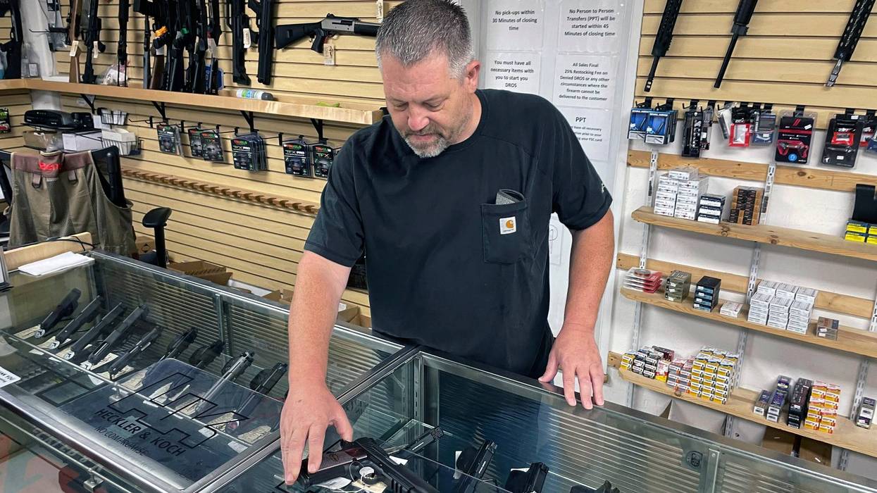 John Parkin, co-owner of Coyote Point Armory displays a handgun at his store in Burlingame, Calif.