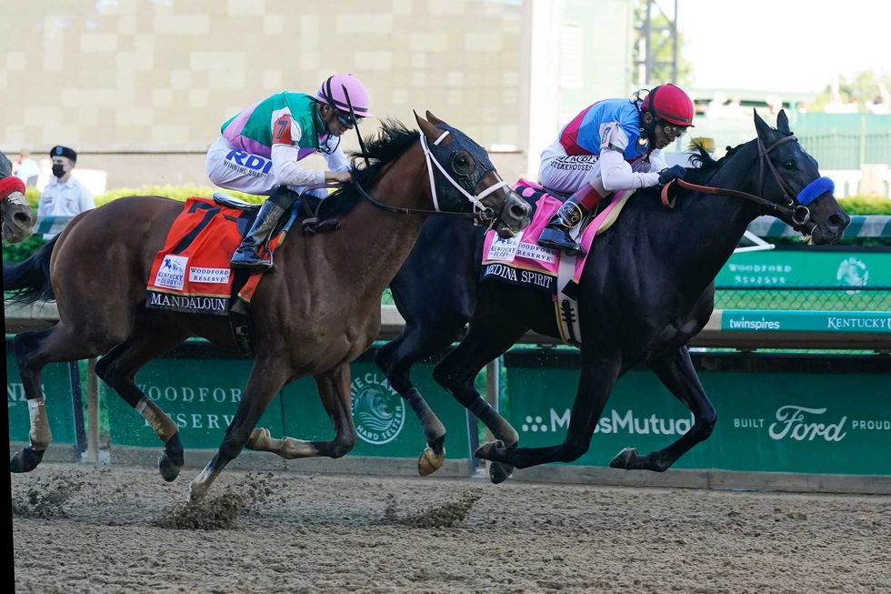 John Velazquez, right, rides Medina Spirit ahead of Florent Geroux aboard Mandaloun to win the 147th running of the Kentucky Derby at Churchill Downs, Saturday, May 1, 2021, in Louisville, Ky