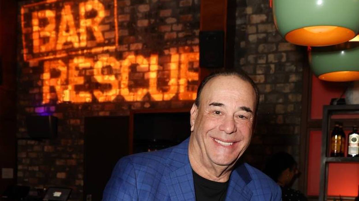 Jon Taffer of ‘Bar Rescue’ posing against a bar