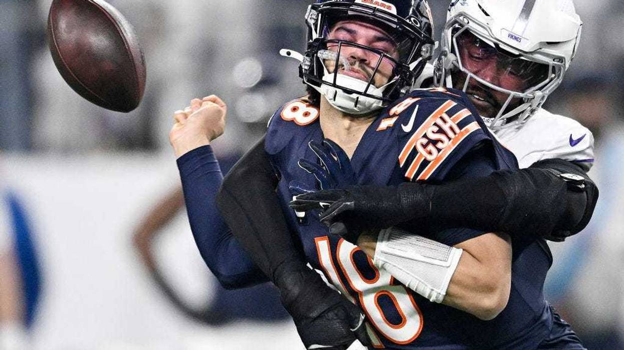 Jonathan Greenard #58 of the Minnesota Vikings strip sacks Caleb Williams #18 of the Chicago Bears during the first quarter at U.S. Bank Stadium on December 16, 2024 in Minneapolis, Minnesota. Minnesota recovered the ball on the play.