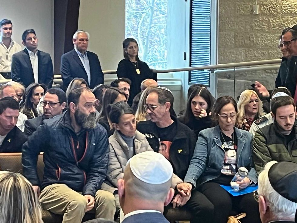 Jonathan Polin (left) and Rachel Goldberg-Polin (second left), the parents of murdered American-Israeli hostage Hersh Goldberg-Polin, sit with Orna, Ronen and Daniel Neutra (center and right) during the service