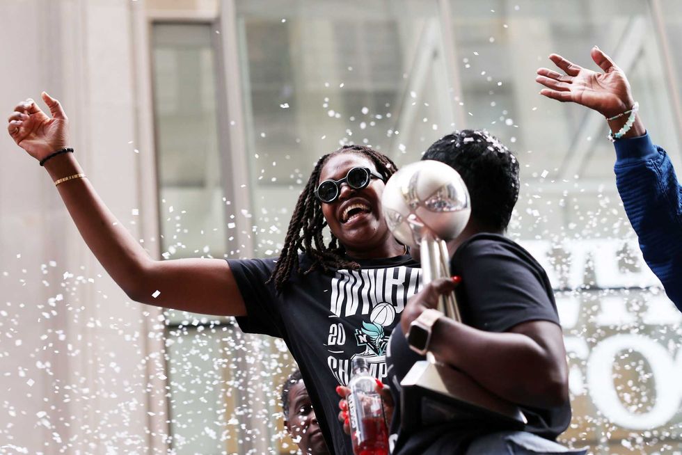 Jonquel Jones #35 of the New York Liberty carries the MVP trophy while waving to the crowd during the New York Liberty Ticker Tape Victory Parade & Rally on October 24, 2024 in New York City