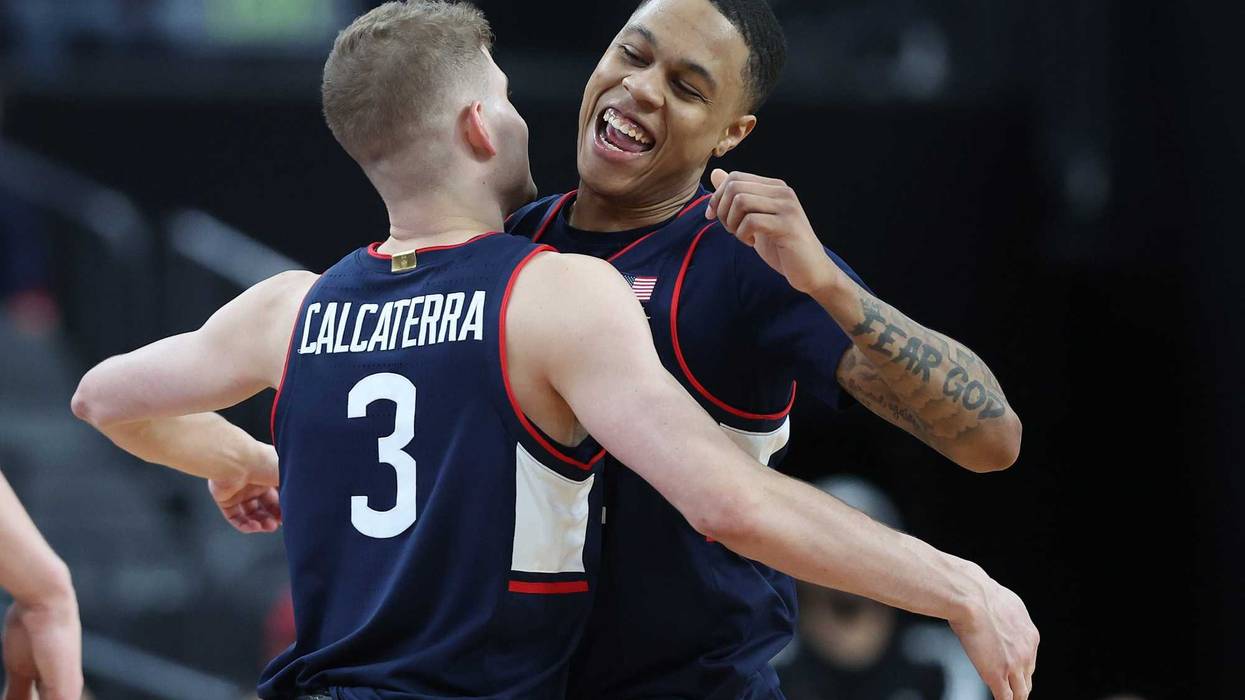 Jordan Hawkins (#24) of UConn celebrates with Joey Calcaterra (#3) as the Huskies blew out Gonzaga to reach the Final Four. Hawkins scored 20 points and was voted Most Outstanding Player in the NCAA West Regional, 3/25/23.
