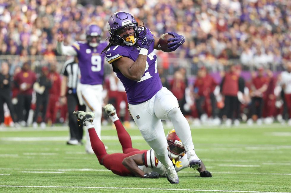 Jordan Mason #27 of the Minnesota Vikings runs for a touchdown during the second quarter against the Washington Commanders at U.S. Bank Stadium on December 07, 2025 in Minneapolis, Minnesota.