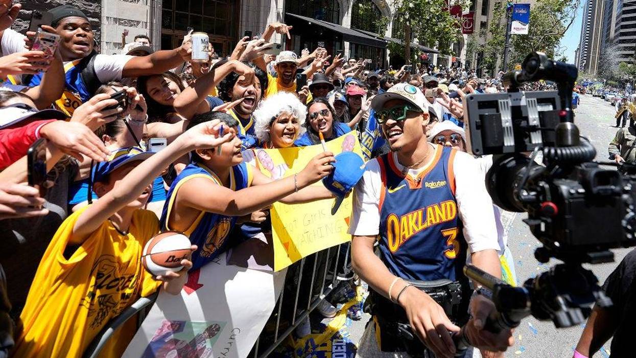 Jordan Poole #3 of the Golden State Warriors celebrates with fans during the Golden State Warriors Victory Parade on June 20, 2022 in San Francisco, California.
