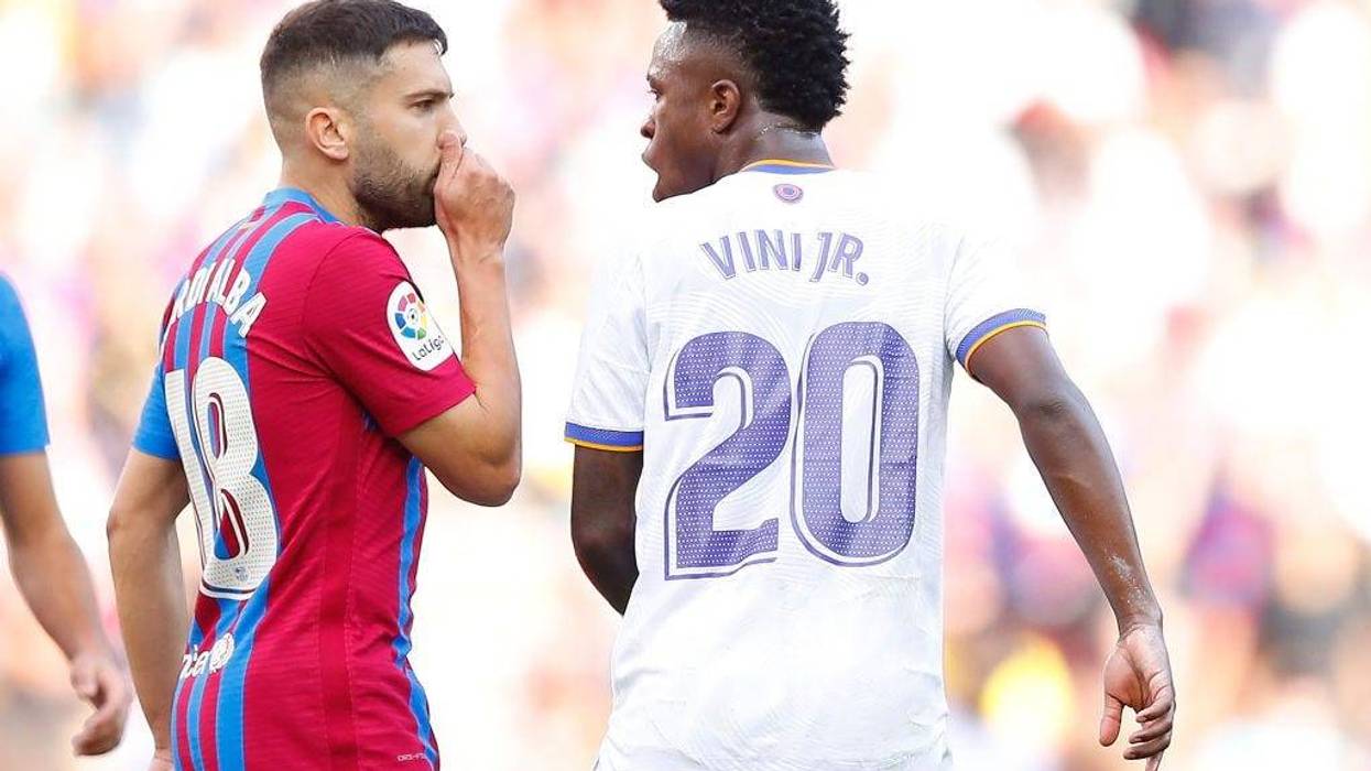Jordi Alba of FC Barcelona discusses with Vinicius Junior of Real Madrid during the LaLiga Santander match between FC Barcelona and Real Madrid CF at Camp Nou on October 24, 2021 in Barcelona, Spain.