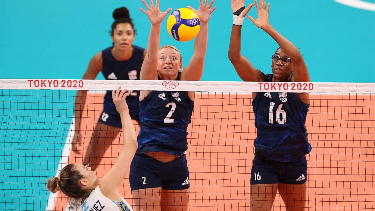 Jordyn Poulter #2 of Team United States and Foluke Akinradewo #16 attempt to block the shot by Elina Maria Rodriguez #1 of Team Argentina during the Women's Preliminary - Pool B on day two of the Tokyo 2020 Olympic Games at Ariake Arena on July 25, 2021 in Tokyo, Japan.