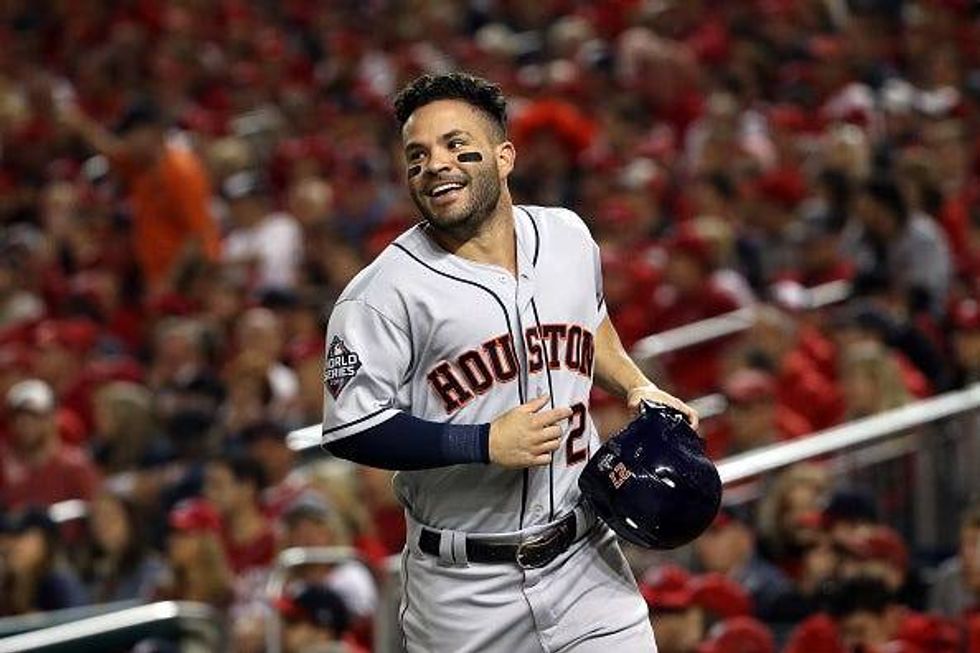 Jose Altuve celebrates scoring a run in the World Series