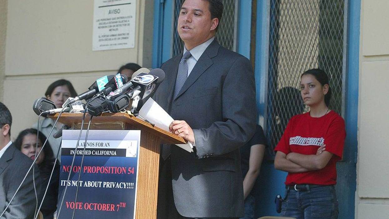Jose Huizar, a board member of the Los Angeles Unified School District and other representatives from Latino organizations hold a news conference to oppose Proposition 54 outside Garfield High School September 8, 2003 in Los Angeles, California.