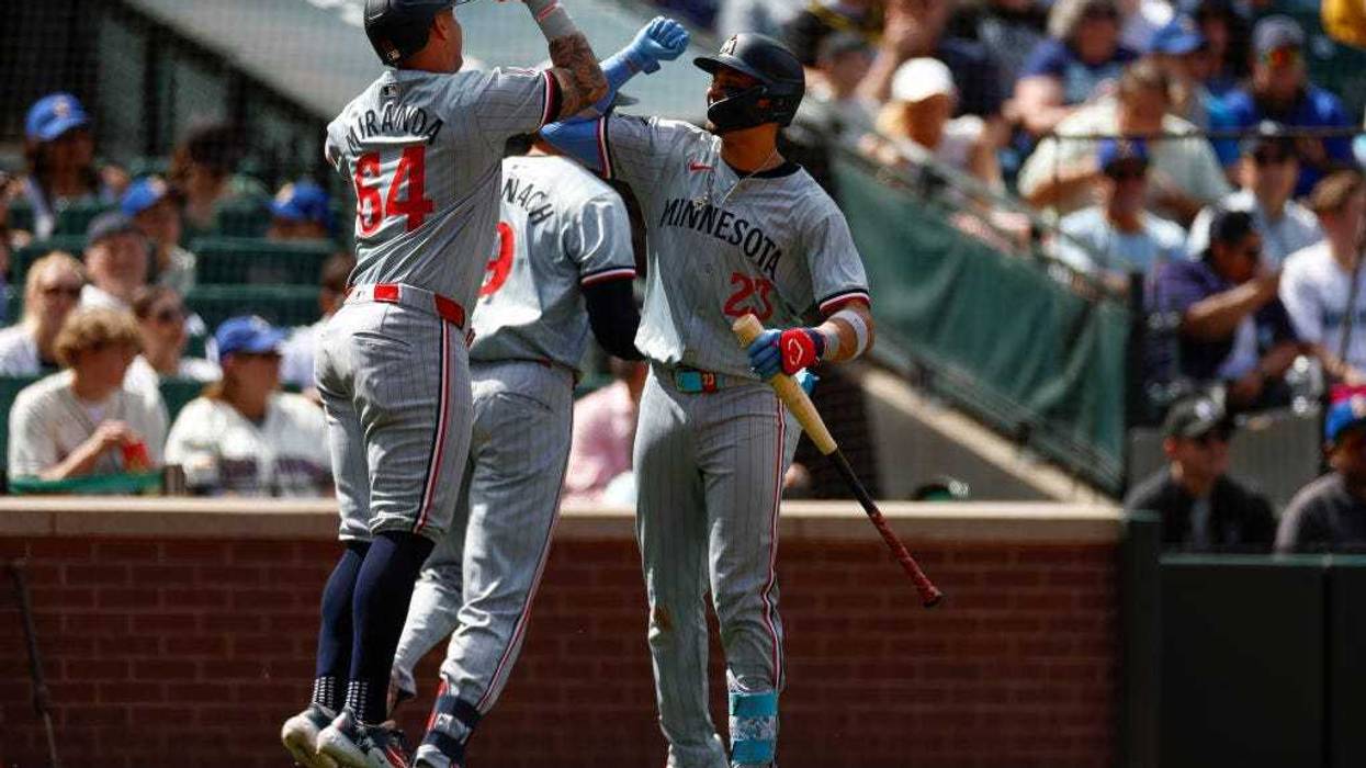 Jose Miranda #64 of the Minnesota Twins bumps Royce Lewis #23 in celebration of a two-run home run hit by Trevor Larnach #9 in the eighth inning during a game against the Seattle Mariners at T-Mobile Park on June 30, 2024 in Seattle, Washington.