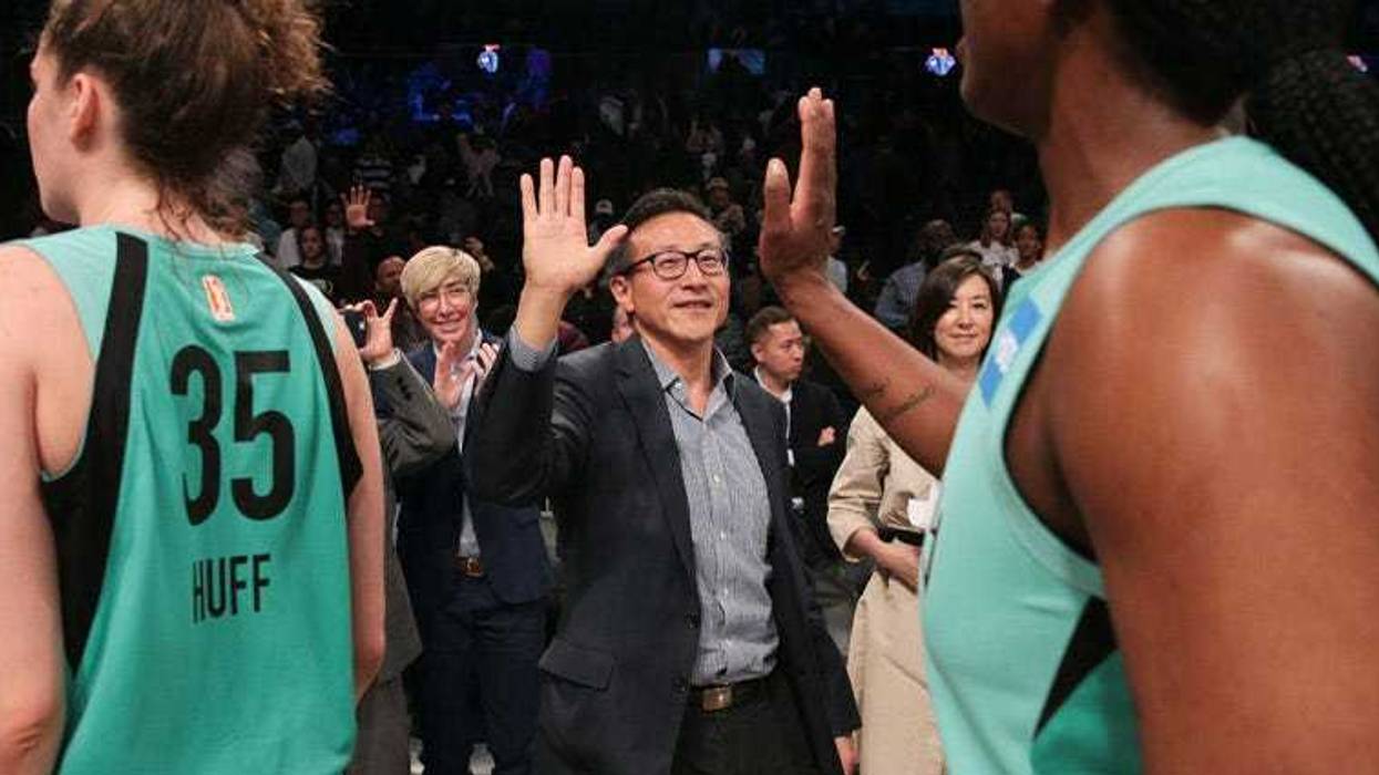 Joseph Tsai high-fives New York Liberty players after their exhibition game against the China national team at Barclays Center on May 5, 2019.