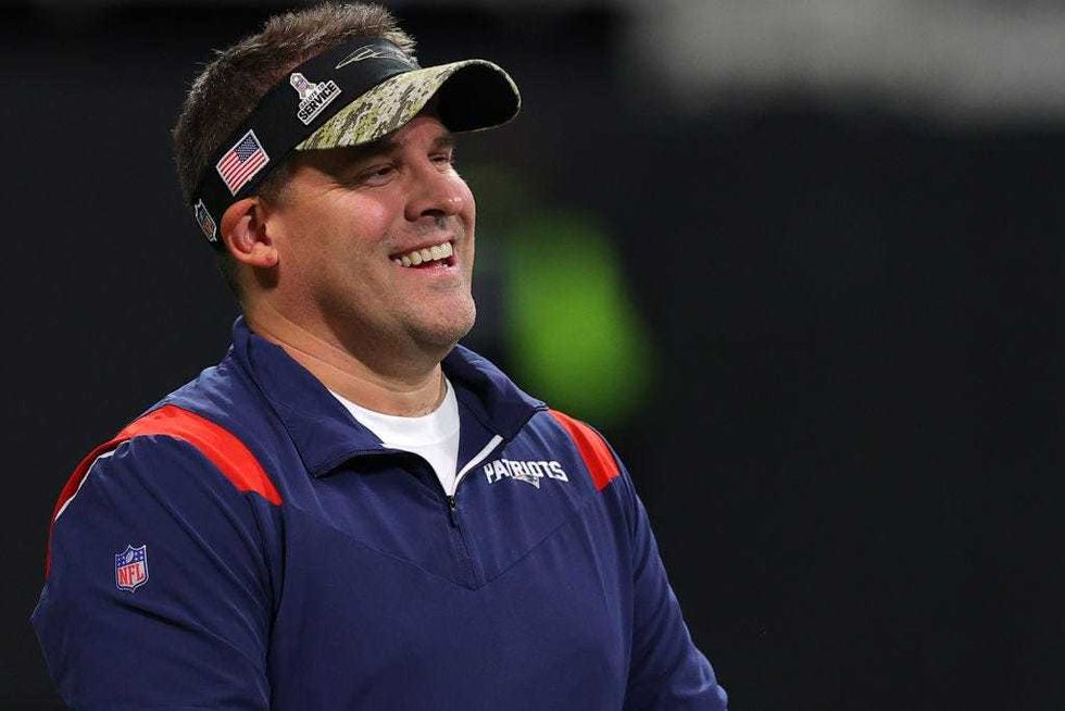 Josh McDaniels of the New England Patriots stands on the field prior to the game against the Atlanta Falcons at Mercedes-Benz Stadium on November 18, 2021 in Atlanta, Georgia.