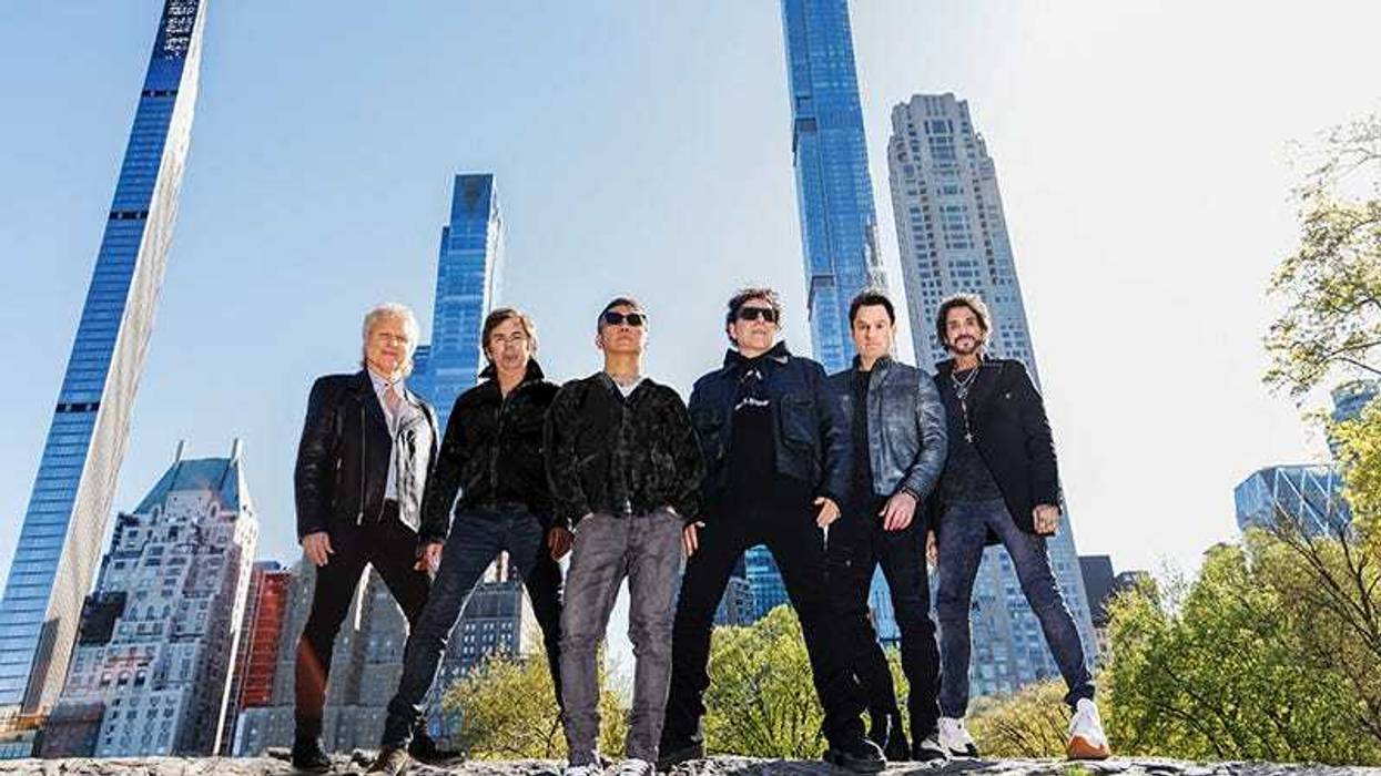 Journey band in front of city skyline