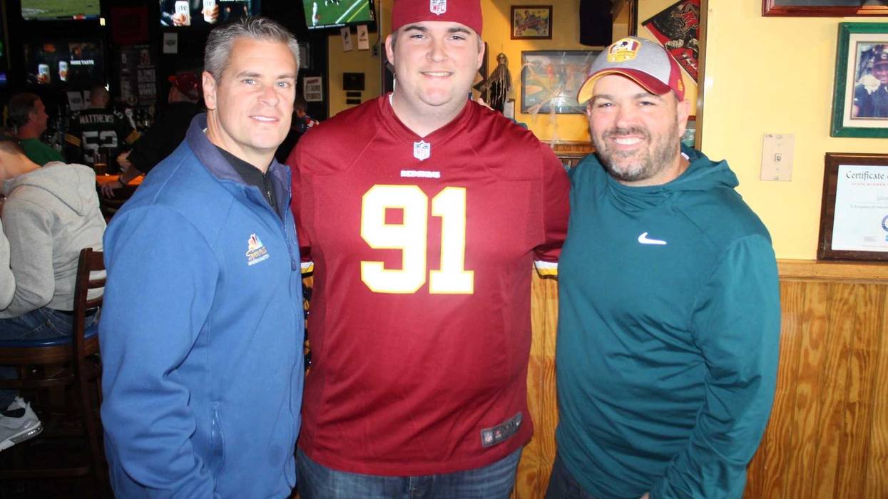 JP and Cakes from The Sports Junkies as well as 106.7 The Fan Street Team, chats with Skins fans at Glory Days Grill in Centreville, Va before kickoff.