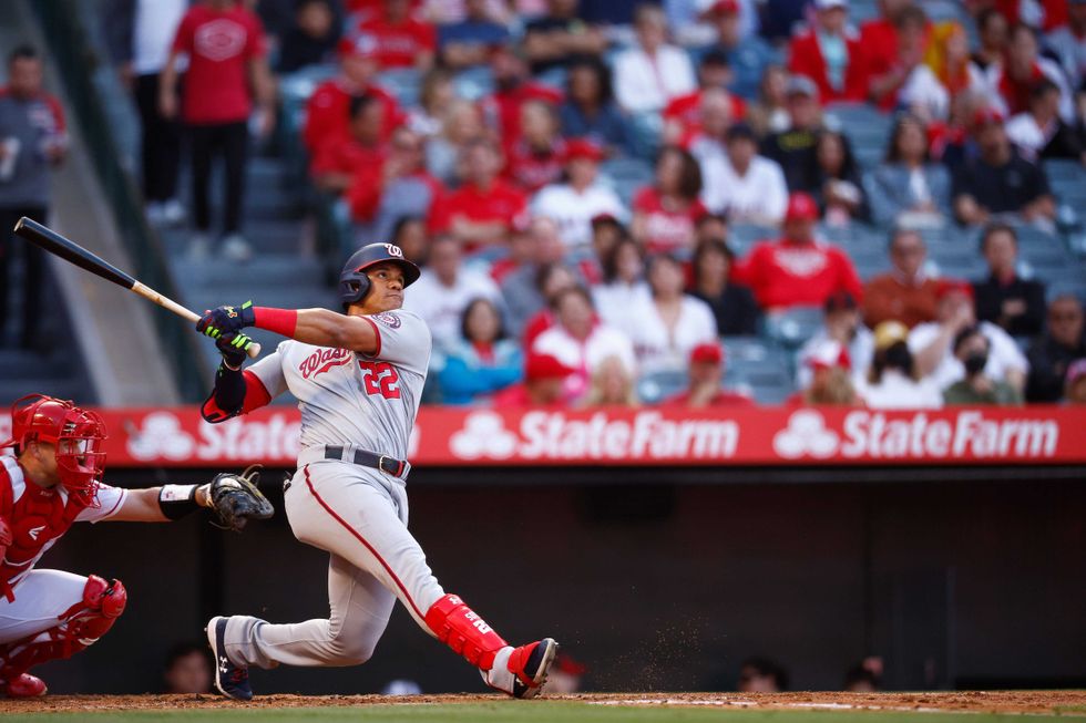 Juan Soto blasts a ball into the outfield.