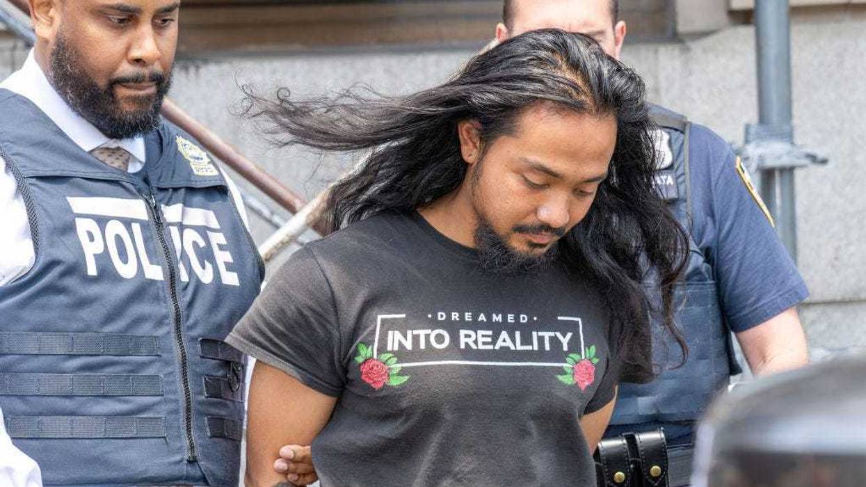 Judd Sanson is pictured in police custody leaving the New York Police Department 110th Precinct station house in Queens on Thursday, June 13, 2024.