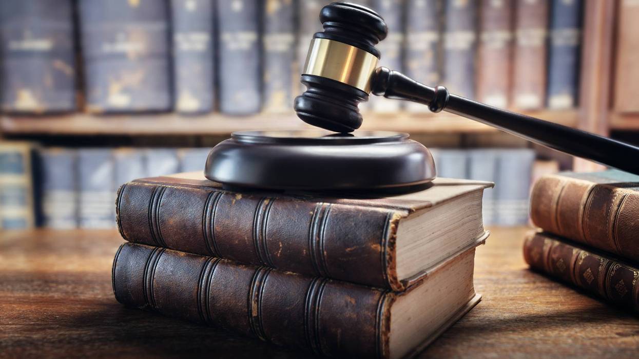 Judge gavel and law books in court background