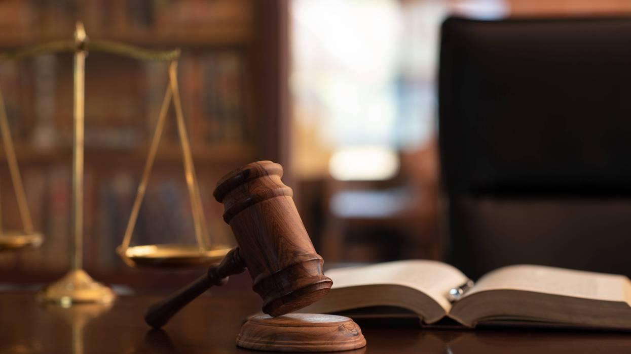 judge gavel, law books and scales of justice on desk